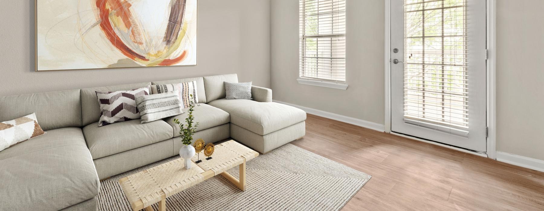 a living room with a couch and a painting on the wall