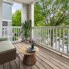 a deck with a couch and a table and a tree