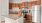 a kitchen with wooden cabinets